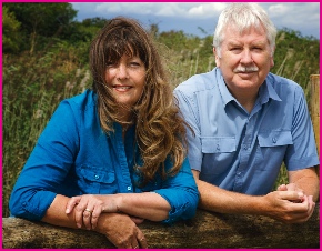 Graham and Lyn Whiteman relaxing over a field fence with a smile